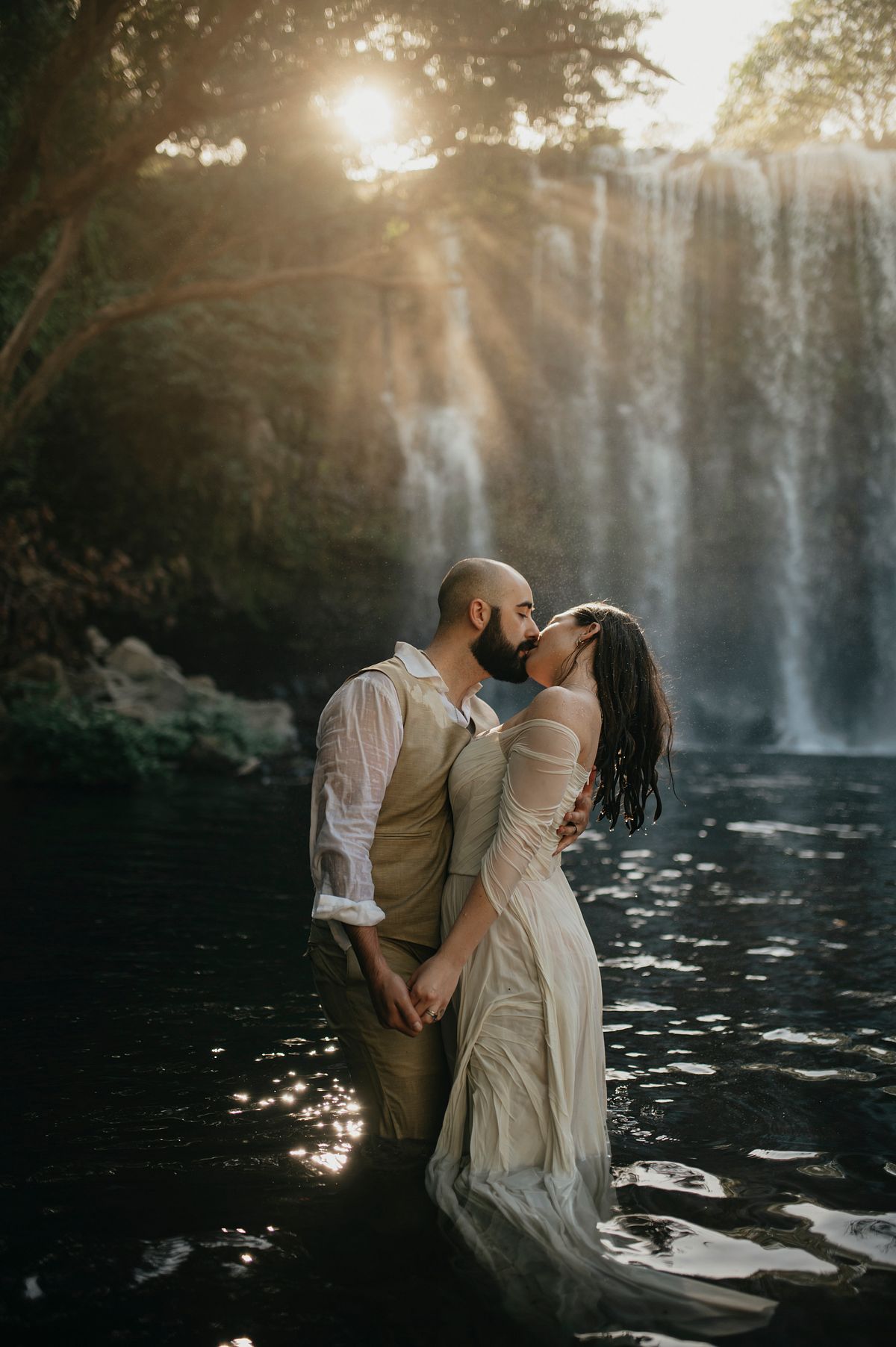Stunning Costa Rican Backdrop: Newlyweds Share a Beautiful Kiss in the Water During Their Photoshoot